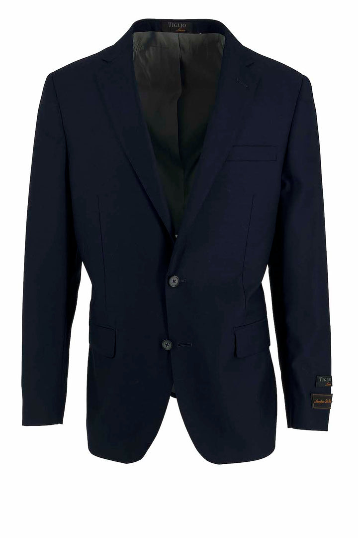 Experience luxury men's fashion with the Tiglio Luxe New Blue Dolcetto Modern Fit Jacket. Crafted from pure wool, this blue blazer by Tiglio Luxe features a modern fit with two buttons and two front pockets. Its timeless design captures the elegance of Italian suits, displayed tastefully against a white background.