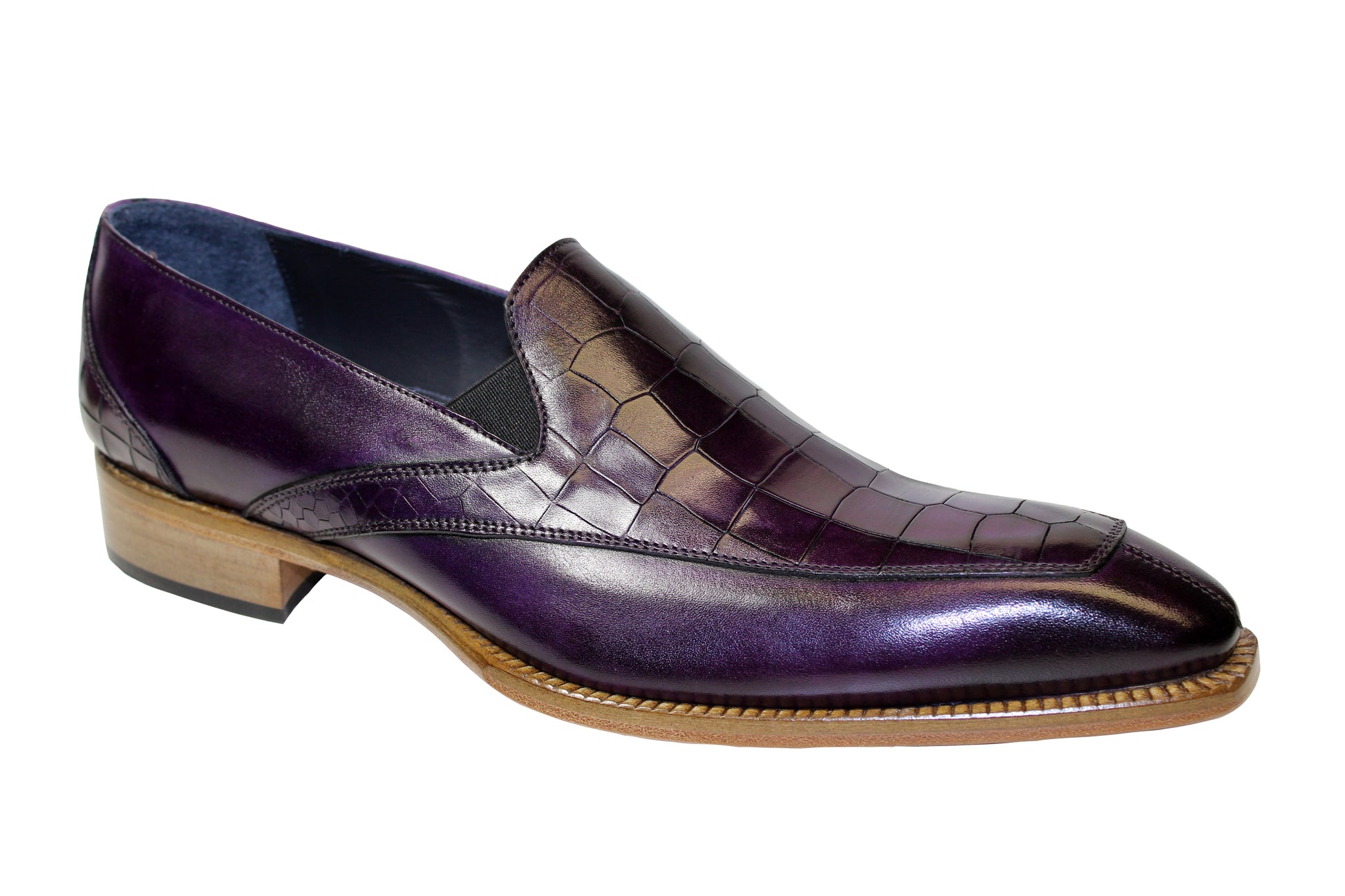 The Duca Di Matiste Trento (Purple) is a luxurious Italian-made shoe from the Duca Di Matiste brand, featuring a gleaming embossed Croco leather with a crocodile pattern, complemented by a low wooden heel and slip-on design.