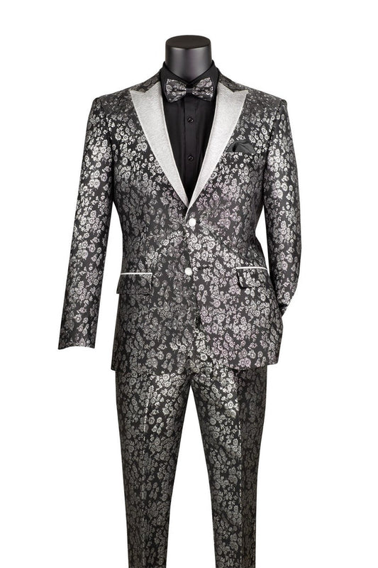 A black mannequin displays the Vinci Suits TSJQ-1, a sleek tuxedo from their Sim Fit 2 Pieces collection, which features a metallic floral pattern, slim fit design, and an elegant matching bow tie. This ensemble includes white lapel detailing and a sophisticated peak lapel design that is both elegant and wrinkle resistant for easy care.