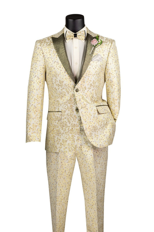 Introducing the Vinci Sim Fit 2 Pieces with Matching Bow Tie Tuxedo Champagne TSJQ-1 by Vinci Suits: a cream-colored slim fit tuxedo crafted from luxurious jacquard fabric, adorned with intricate gold floral patterns. This elegant ensemble features a peak lapel and comes complete with a matching bow tie, white shirt, and a single pink boutonniere.