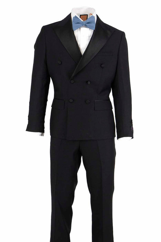 Displayed on the mannequin is a Tiglio Luxe Pistoia Double Breasted Navy Tuxedo, expertly crafted from fine Italian wool and featuring a sophisticated European fit. The ensemble is completed with elegant black lapels and paired with a pale blue bow tie, epitomizing the refined style characteristic of Tiglio Tuxedos.