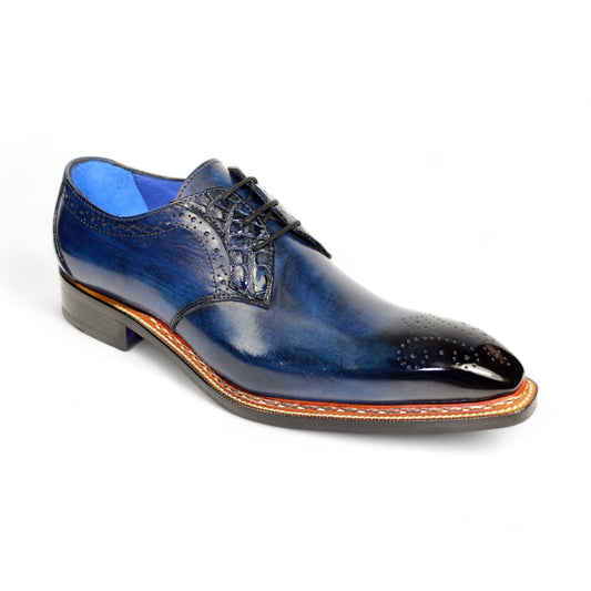 The Fennix "Tyler" Navy Shoes, crafted by Fennix of Italy, are polished dark blue leather dress shoes showcasing exquisite brogue detailing and featuring a wooden heel, set against a white background.