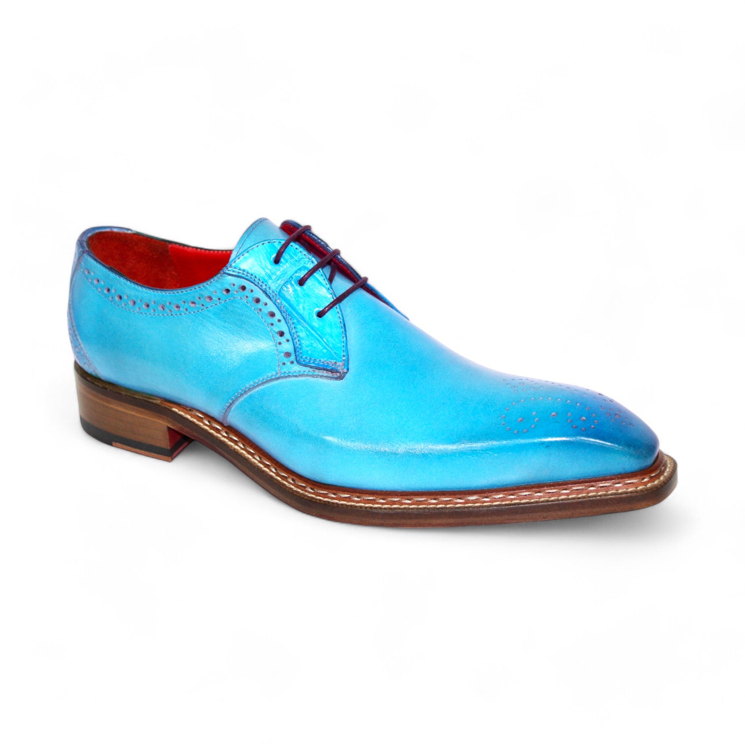 Meticulously designed in Italy by Fennix of Italy, the Fennix "Tyler" Turquoise Shoes boast a vibrant blue leather with an eye-catching alligator-textured finish. The interior is lined in red, complemented by a brown sole, ornate perforations, and dark red laces.