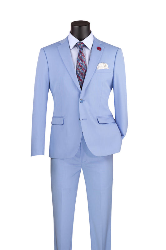 The Vinci Ultra Slim Fit Stretch Wool Feel Suit Light Blue USDX-1 by Vinci Suits is displayed on a mannequin, complemented by a white shirt, patterned tie, and pocket square. The Notch Lapel Jacket enhances the sleek design, forming an elegant ensemble ideal for any occasion.