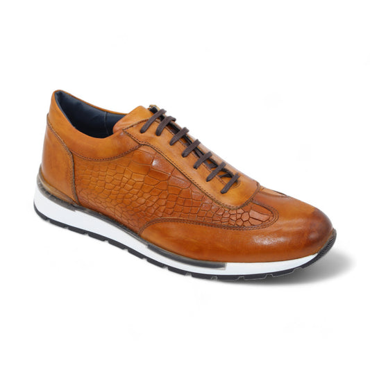 The Duca Di Matiste Varsi (Cognac) by Duca Di Matiste is an Italian-made sneaker with a crocodile-patterned embossed leather upper, complemented by a white midsole and black outsole on a white background.