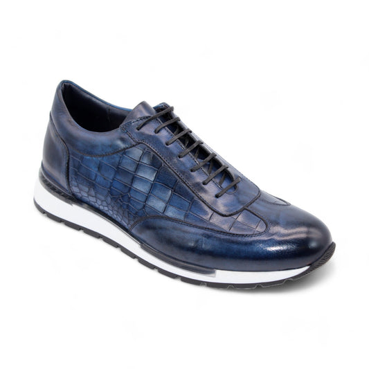 The Duca Di Matiste Varsi (Navy) sneaker by Duca Di Matiste is crafted from embossed croco leather in a rich blue hue, featuring a textured, grid-like pattern and a stylish white sole. Made in Italy with exquisite attention to detail, it is showcased elegantly on a white background.