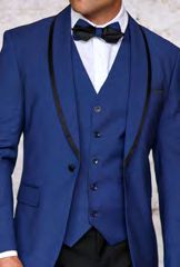 A person wearing the Insomnia Sunset 3PC Slim Fit Sapphire Black Tuxedo Suit is styled with a reversible vest, complemented by a white dress shirt and a sleek black bow tie.