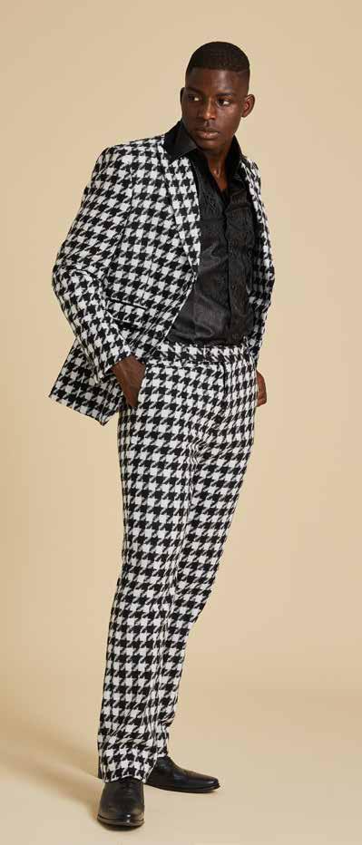 A person wearing a modern black shirt and the Inserch Wool Blend Houndstooth Check Peak Lapel Suit BL264-41 in Black/White, featuring a sleek suede trim, stands against a plain background.