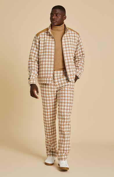 Someone is dressed in the Inserch Wool Blend Houndstooth Suit JS264B-09 Khaki, featuring a jacket and matching regular-fit pants. The outfit includes a high collar, shoulder patches, and a sleek 2-way zipper, set against a beige background.