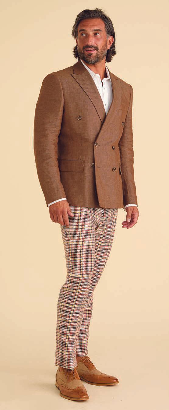 A person is showcasing a contemporary style with a yellow jacket over a brown shirt and Inserch Micro Check Pants P265-64 Mocha, paired with dark brown boots, all set against a plain background.