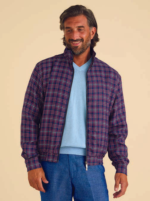 A man wearing the Inserch Micro Check Suit JS266-126 Purple, a stylish regular fit suit featuring a patterned blue and purple check design with a printed lining, smiles against a plain background.