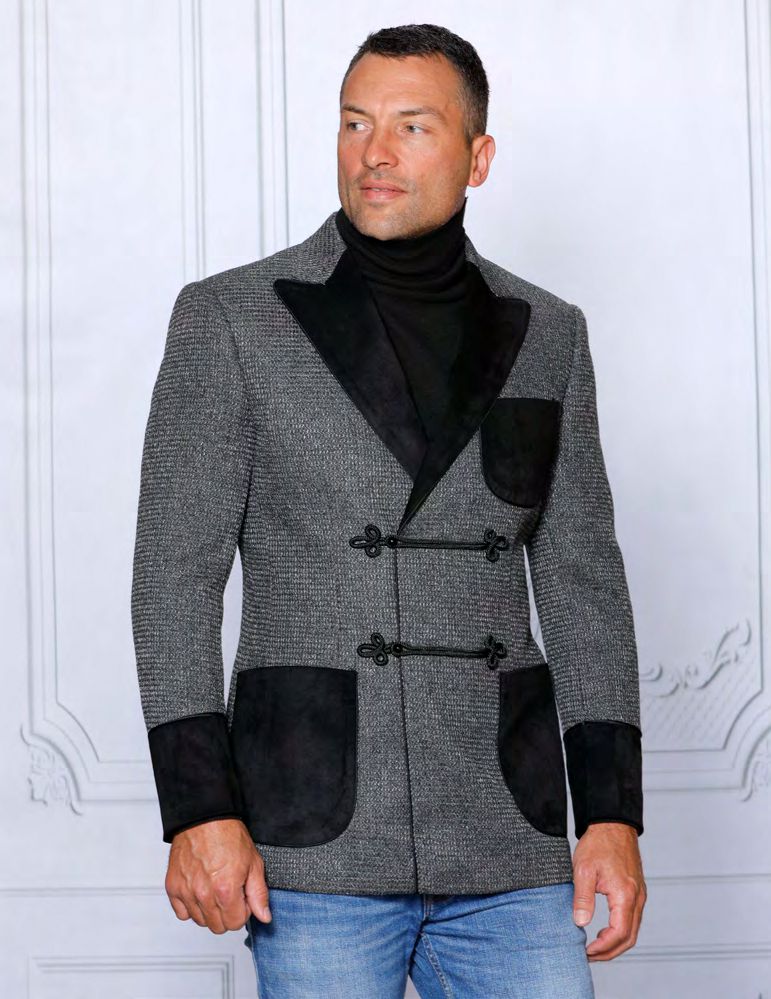 A person wearing the INSOMNIA MZS-533 Tailored Fit Charcoal Fancy Sport Coat with black accents and blue jeans stands against a white, textured background.