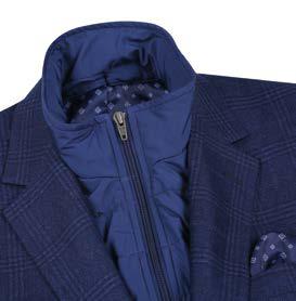 The Alessandro Vitello by Renoir New Slim Fit Sport Coat 294-41 combines a navy blue color with a subtle checkered pattern. It features a contrasting blue quilted inner layer and includes a pocket square. Expertly crafted from a refined blend of polyester and rayon, this sophisticated sport coat is side-vented for enhanced comfort and mobility.