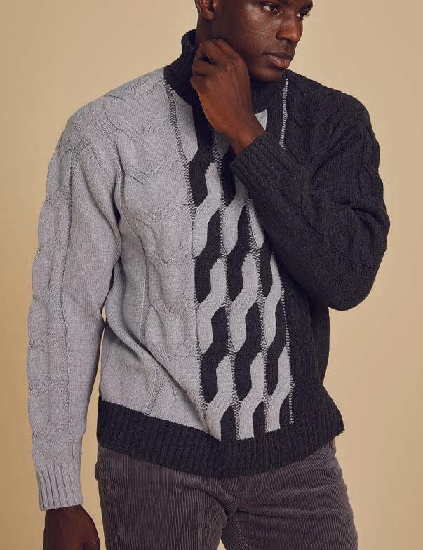 A person wearing the Inserch Cotton Blend Cable Knit Turtleneck Sweater SW303-04 in Light Grey paired with dark pants stands against a beige background.