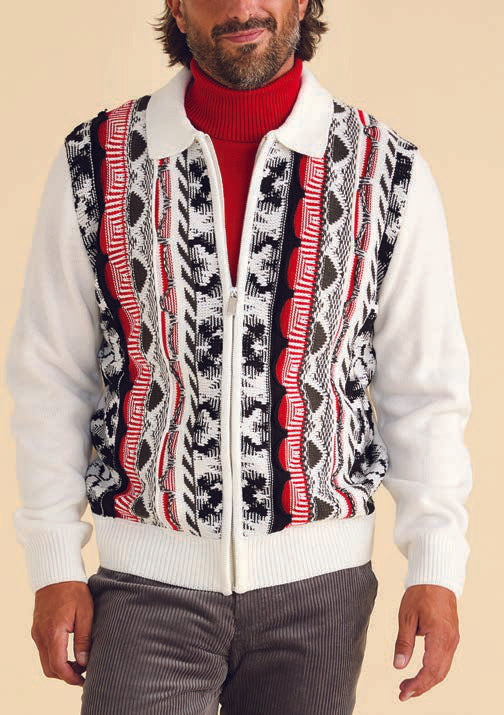 A man wearing the Inserch 3D Intarsia Full Zip Sweater SW907-02 White adorned with red, black, and white designs over a cozy red turtleneck, paired with gray synthetic blend pants.