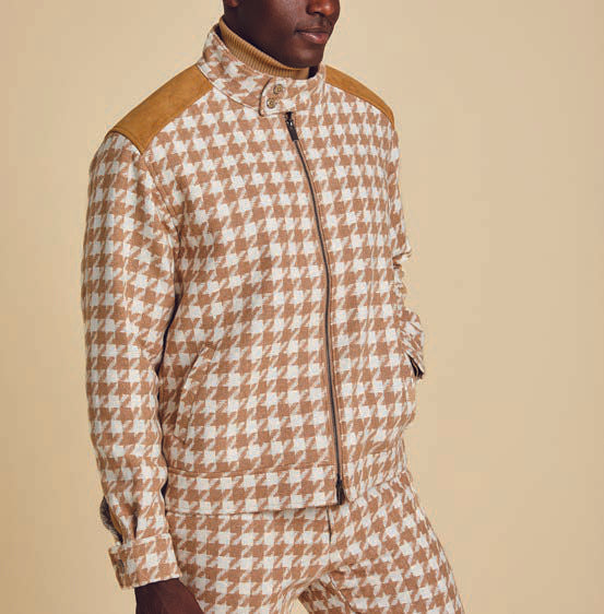 Someone is dressed in the Inserch Wool Blend Houndstooth Suit JS264B-09 Khaki, featuring a jacket and matching regular-fit pants. The outfit includes a high collar, shoulder patches, and a sleek 2-way zipper, set against a beige background.