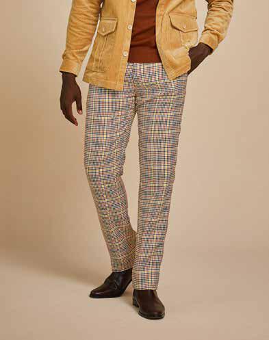 A person is showcasing a contemporary style with a yellow jacket over a brown shirt and Inserch Micro Check Pants P265-64 Mocha, paired with dark brown boots, all set against a plain background.