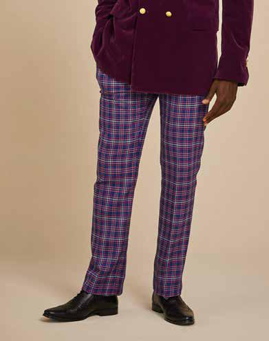 A man wearing the Inserch Micro Check Suit JS266-126 Purple, a stylish regular fit suit featuring a patterned blue and purple check design with a printed lining, smiles against a plain background.