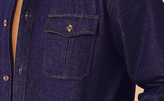 A person wearing the Inserch Denim Shirt Jacket JS003-10 in a dark denim blue with brown accents and novelty buttons looks downward against a plain background.