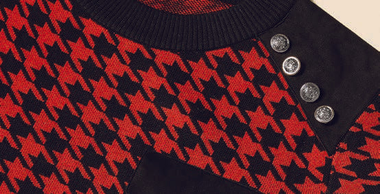 A person wearing the Inserch Cotton Blend Houndstooth Crew Neck Sweater in red, featuring a military-inspired design with black shoulder details and a pocket.