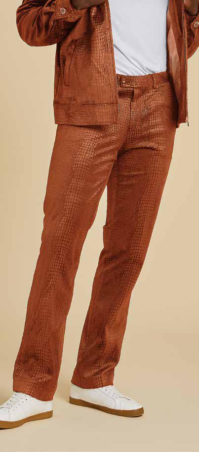 Dressed in the Inserch Suede Snake Skin Pants P268S-104 Cognac from Inserch, someone is seen in a textured metallic orange suit ensemble paired with a white shirt and sneakers, set against a beige background.