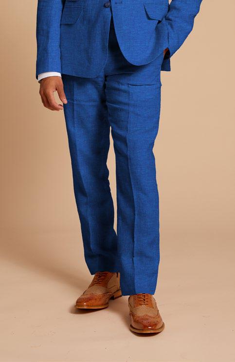 A man wearing the Inserch Linen Pants P31, tailored from European flax, stands against a beige background in a blue suit, complemented by tan dress shoes.