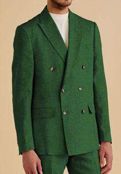 An individual dressed in the Inserch DB Linen Suit BL661-00200 Emerald, featuring a modern tailored fit, paired with a crisp white shirt is posed against a beige background.