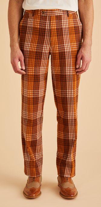 Dressed in Inserch's Seersucker Gingham Pants P272-00027 Aztec, paired with brown brogues, a person stands against a beige background, flawlessly embodying modern style with touches of premium cotton.