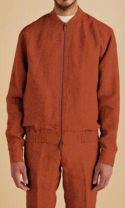 A person dressed in the Inserch Linen Bomber Jacket Suit JS660-00109 in Burnt Orange, with the jacket zipped up against a beige background.