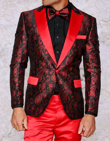 A man dresses stylishly with the INSOMNIA MZS-551 Slim Fit Red Woven Sport Coat by Insomnia, featuring woven sport coat details, red and black paisley patterns, matching red lapels, pocket square, and satin pants. He completes the look with a black shirt and a red bow tie.