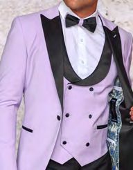 A person dressed in the INSOMNIA ROME 3PC Slim Fit Lavender Spandex Tuxedo Suit by Insomnia, featuring black lapels and buttons, paired with a crisp white shirt and a stylish black bow tie for a sleek slim fit look.