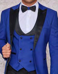 A person confidently holding the lapel of their Insomnia Rome 3PC Slim Fit Royal Spandex Tuxedo Suit, featuring a blue design with black lapels, paired with a sleek black bow tie over a crisp white shirt.