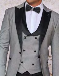 Someone is wearing the stylish INSOMNIA ROME 3PC Slim Fit Grey Spandex Tuxedo Suit by Insomnia, featuring a sleek design with black lapels, a double-breasted waistcoat, and elegantly paired with a crisp white shirt and an elegant black bow tie.