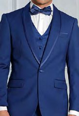 A man wearing the INSOMNIA SUNSET 3PC Slim Fit Sapphire Tuxedo Suit, featuring a reversible vest and bow tie from the brand Insomnia, stands against a neutral background.