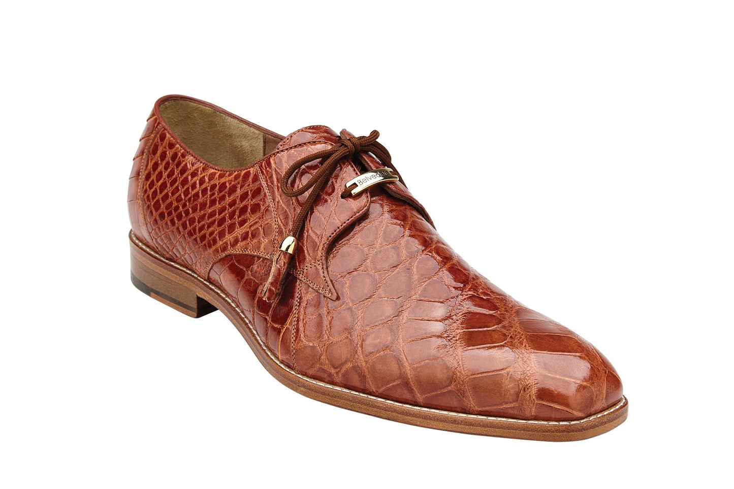 The Belvedere - Lago, a genuine alligator dress shoe in Cognac, style number 14010, boasts a luxurious crocodile pattern with lace-up closure and leather lining. It's an ideal choice for menswear shoes enthusiasts and is presented in a side profile. Available in-store from BELVEDERE.