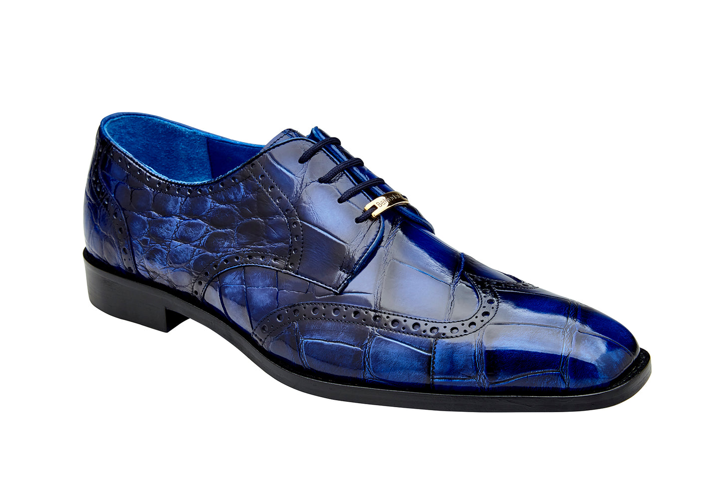 The Belvedere Santo dress shoe, made from genuine American alligator leather in antique blue, showcases classic wing-tip styling with black laces and a low heel, as seen from the side.