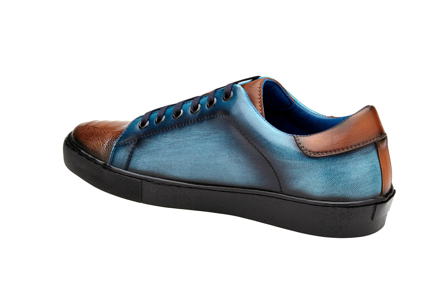 A stylish Belvedere sneaker in Antique Brandy and Antique Ocean Blue, made from genuine ostrich and soft Italian calf leather, showcasing a textured toecap, black sole, and tassel laces for added flair.