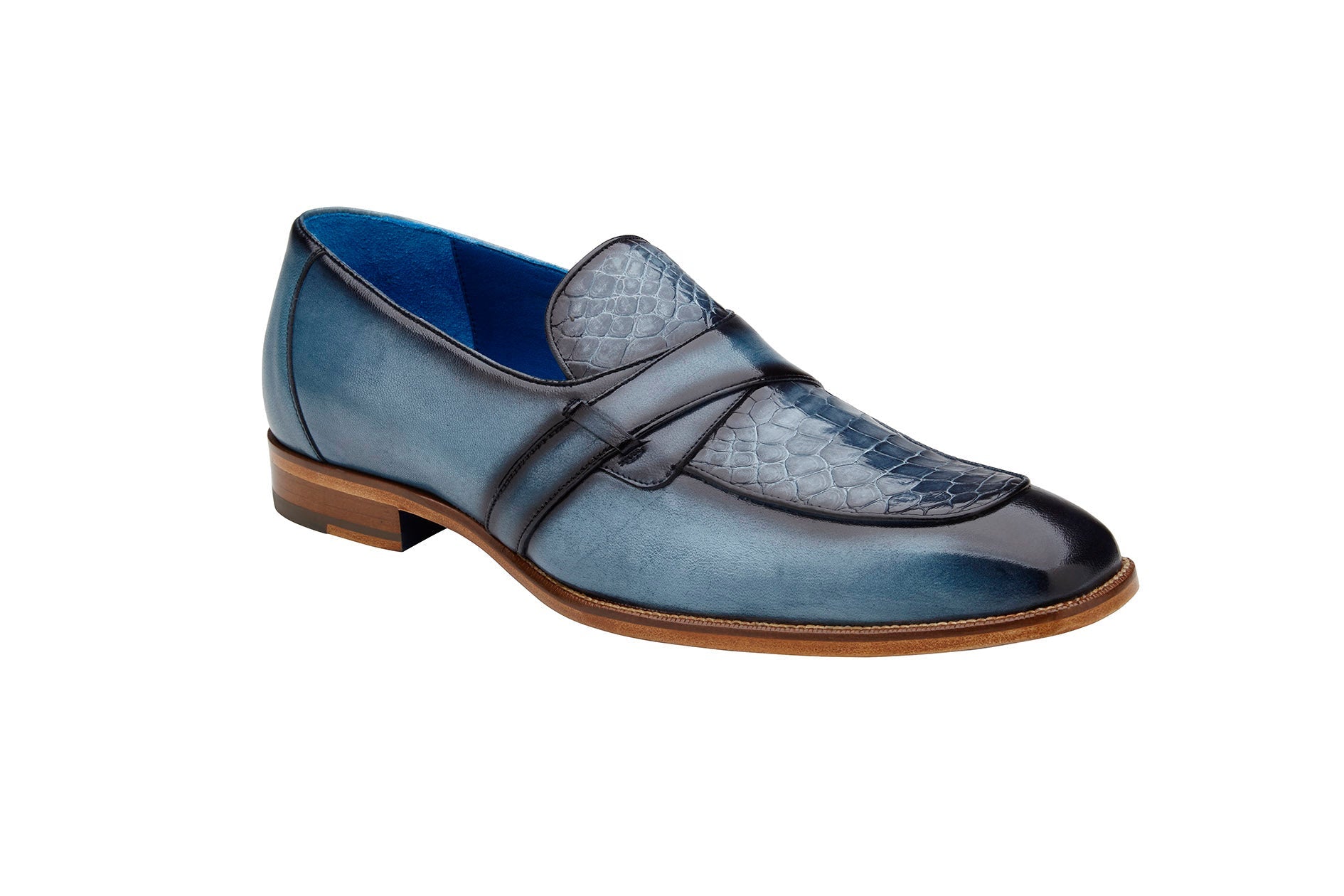 Introducing the Belvedere - Tornado, a stylish slip-on loafer crafted from Genuine American Alligator and Italian Calf leather in an antique blue jean color. This dress shoe features a textured upper and a wooden sole, beautifully showcased from the side.