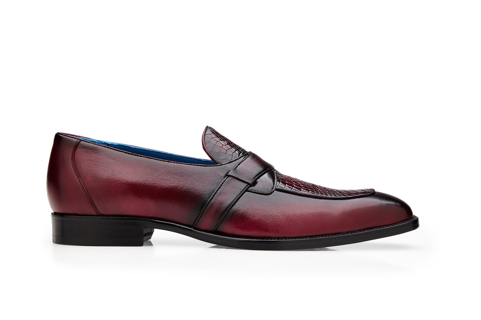 Displayed against a white background is the Belvedere - Tornado, Genuine American Alligator / Italian Calf Dress Shoe in Antique Burgundy by BELVEDERE. This slip-on loafer features a textured pattern on the top and a low heel.