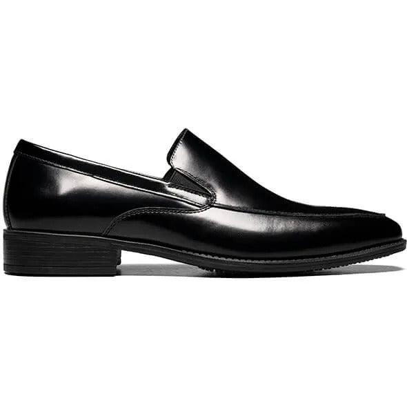 The Stacy Adams ALDRICH Moc Toe Slip On (style number 20193-001) features a sleek black leather upper and a cushioned insole, presented on a white background.