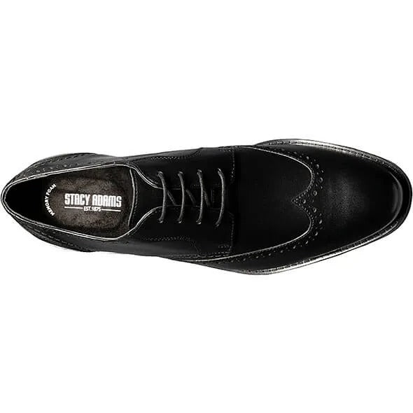 The Stacy Adams Barlow Wingtip Oxford in black, style number 20197-001, is crafted from burnished leather featuring brogue detailing and a lace-up design. It offers ultimate comfort with its Memory Foam footbed.