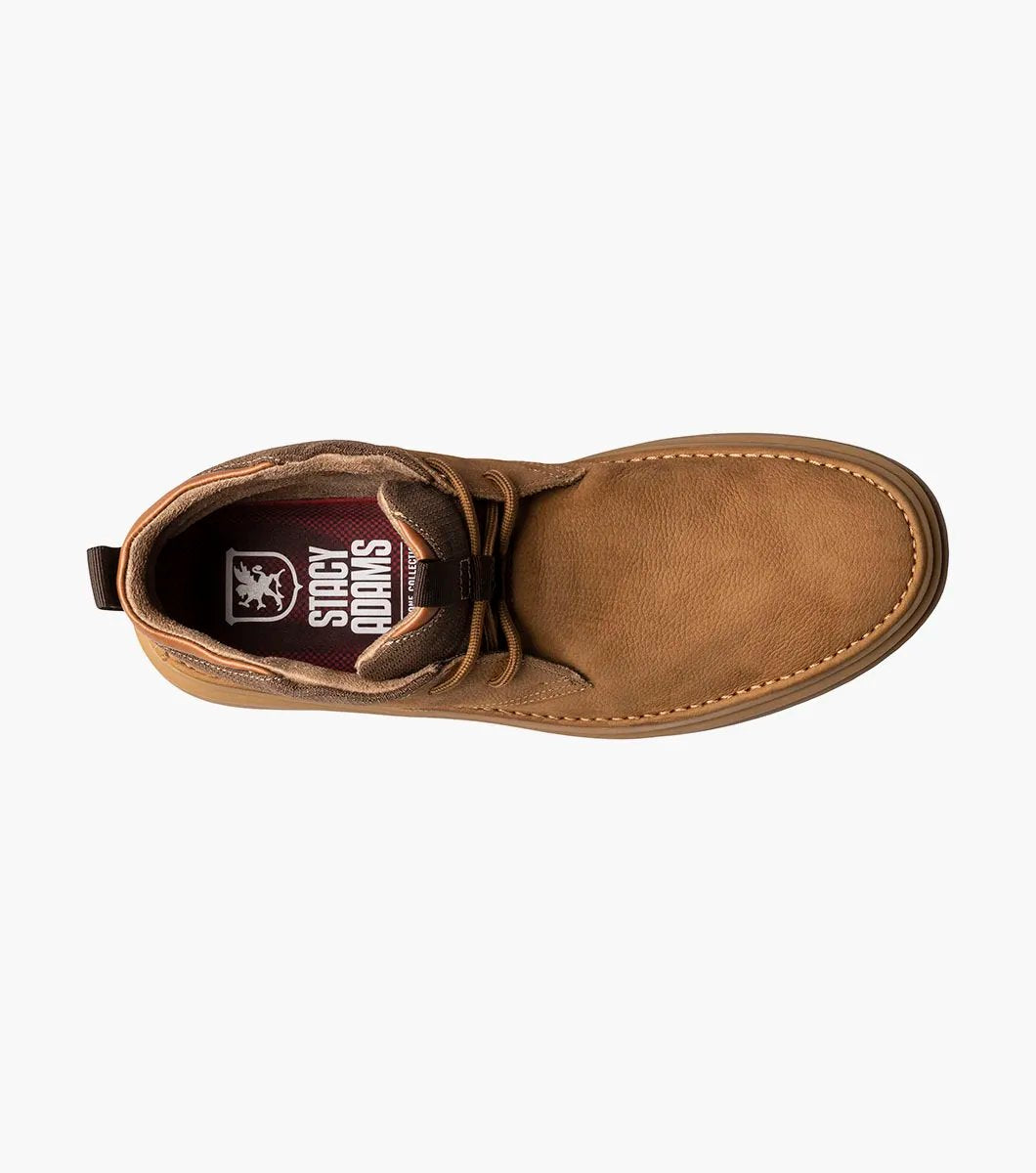 The Stacy Adams DELSON Plain Toe Chukka Boot in camel features a sleek brown suede leather upper with matching laces and a tan rubber sole, showcased from a frontal perspective.