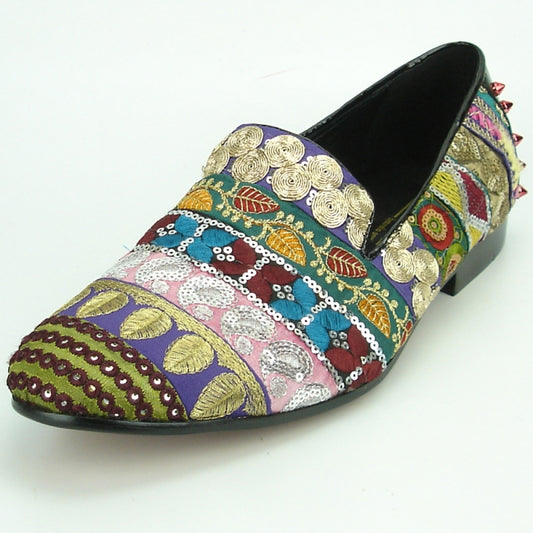 The FI-7228 Multi Color by Fiesso is a vibrant slip-on shoe adorned with multi-color embroidery and geometric designs, enhanced with gold swirls, sequins, and small studs on the heel, epitomizing the signature style of Fiesso by Aurelio Garcia.