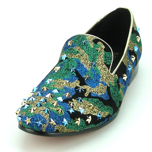 The FI-7145 Multi Blue Slip on by Fiesso boasts a striking camouflage pattern in green, blue, and gold, elegantly embellished with metallic studs. This loafer by Fiesso features a sophisticated leather lining, providing both comfort and style for every occasion.