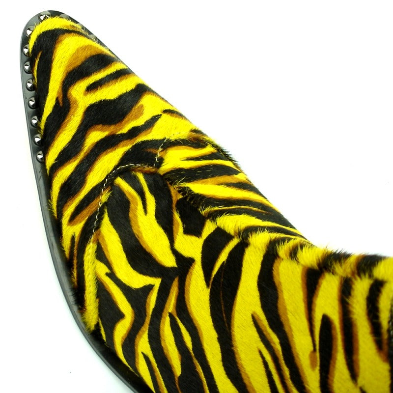 The FI-7315 Yellow Black Leopard Boot by Fiesso features a tiger-striped design in yellow and black, complemented by a pointed toe, studded sole, and cushioned insole for enhanced comfort.