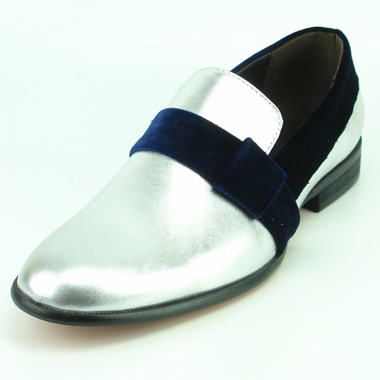 The FI-7356 Silver Fiesso by Aurelio Garcia is a fashion shoe that combines trendiness and elegance, featuring a metallic silver and blue loafer design with a black heel and a wide velvet strap across the top.