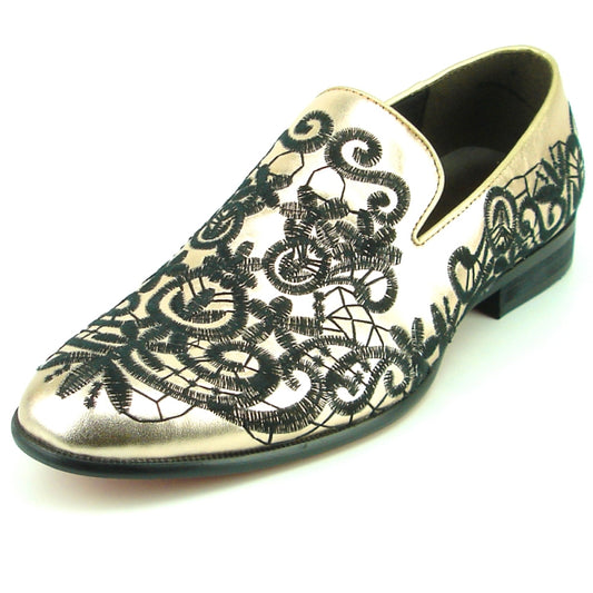 The FI-7358 Gold Fiesso by Aurelio Garcia slip-on fashion shoe showcases intricate black lace-like patterns on its leather upper surface.