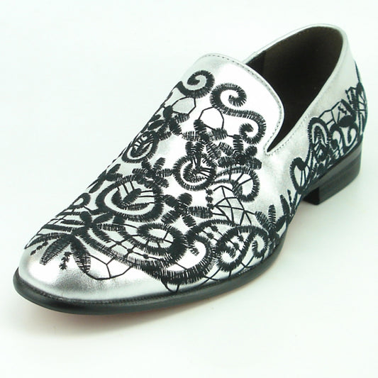 FI-7358 Silver Fiesso by Aurelio Garcia from Fiesso features a silver leather slip-on design with black ornate embroidered lace, making it a true fashion statement.