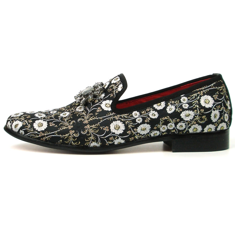 The FI-7386 Black Flowers Slip-on by Fiesso features ornate white floral embroidery and a decorative jewel on top. With a luxurious red interior lining, cushioned insole, and black sole, this stylish slip-on from Fiesso by Aurelio Garcia combines comfort with elegance effortlessly.