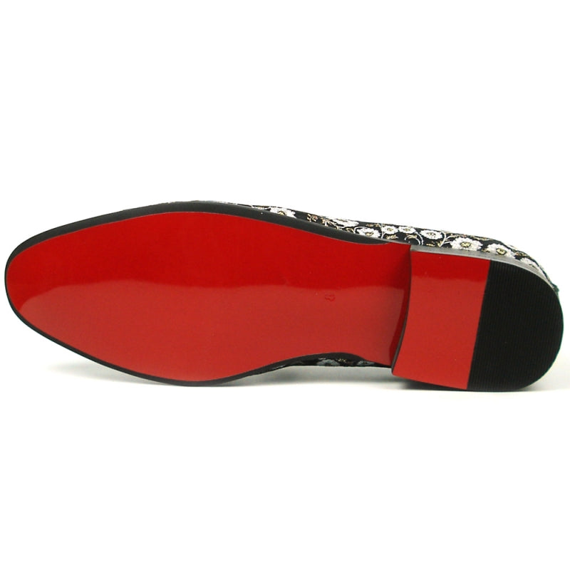 The FI-7386 Black Flowers Slip-on by Fiesso features ornate white floral embroidery and a decorative jewel on top. With a luxurious red interior lining, cushioned insole, and black sole, this stylish slip-on from Fiesso by Aurelio Garcia combines comfort with elegance effortlessly.